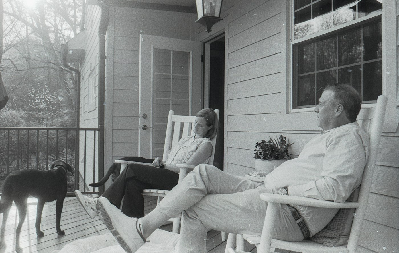 A couple relaxing on the porch of their longtime home